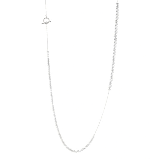 Long sterling silver beaded necklace with graduated sphere design, toggle clasp, and delicate chain extension on white background