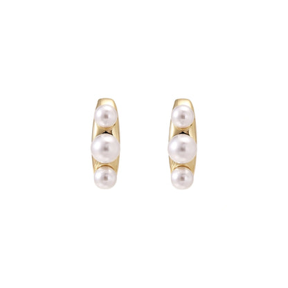 14K gold-plated curved stud earrings with three white freshwater pearls aligned vertically on cream background